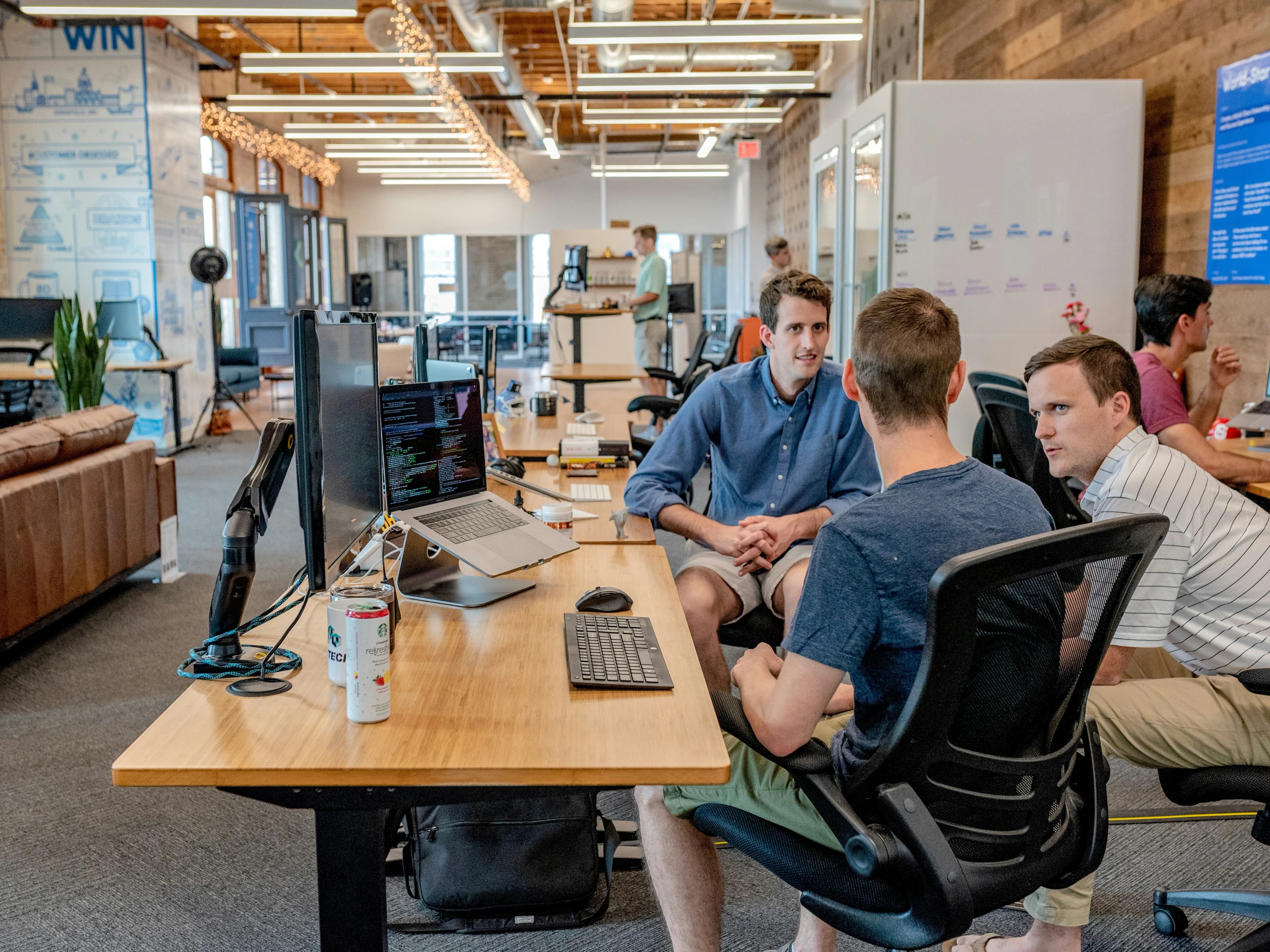 Team members discussing work in an open studio